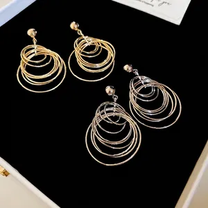 Minimalist multi-layer nested round hoop earrings in polished gold and silver finish