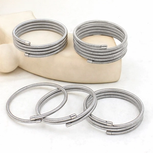 Exaggerated silver stainless steel spiral coil bangles in multi-layer stacked design