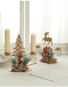 Golden Christmas candle holder with metal deer and tree shapes, pine needles, and berries