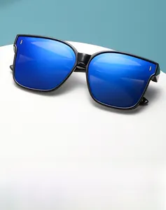 Close-up of black frame sunglasses with blue mirrored lenses and metal rivets
