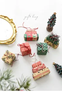 Detailed view of various Christmas gift bags with festive patterns and cotton rope ties