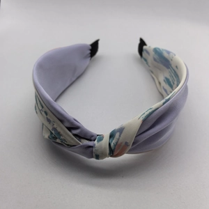 Detail of elegant purple and patterned fabric headband with a stylish knotted design