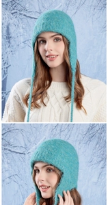 Close-up of blue knitted wool beanie featuring ear flaps and long straps in winter
