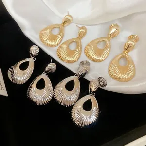 Water drop earrings set with radiating metal textures in gold and silver finishes