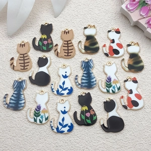 Detailed view of 15 colorful enamel cat charms for DIY jewelry making and crafts