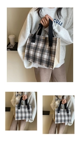 Detail view of stylish checkered canvas tote bag with black strap handles and plaid design