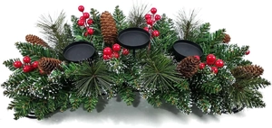 Detailed view of Christmas candle holder with red berries and snowy pine needles