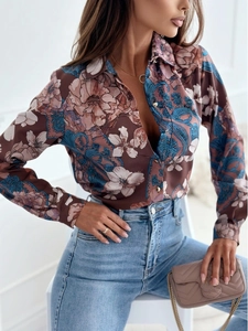 Detail of floral paisley print long sleeve satin shirt with metallic button closure