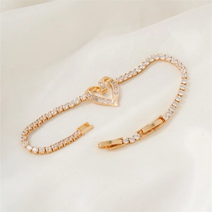 Gold heart tennis bracelet with crystal cubic zirconia and adjustable folding clasp closure