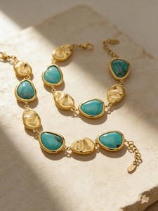 Detailed macro view of 18K gold plated hammered texture bracelet with turquoise inlay