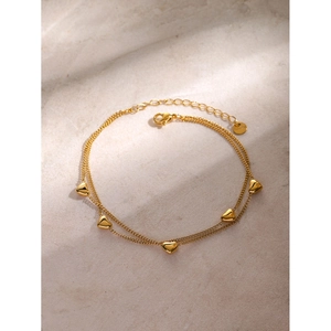 Detail of 16k gold double-layered anklet with five mini 3D heart charms and lobster clasp