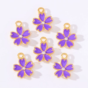Detail showing six purple enamel cherry blossom charms with rhinestones and gold loops