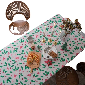 Christmas tablecloth with green holly leaves and red heart prints on cream fabric
