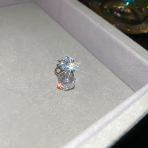 Macro shot of silver zircon stud earrings with starburst effect in a jewelry box