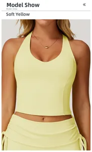 Detail of light yellow yoga vest featuring a deep V-neckline and athletic racerback design