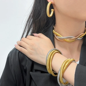 Three-tone woven tubogas jewelry set with necklace, earrings and bracelets on model