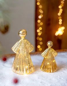 Detail of warm white LED glowing mercury glass angel ornaments with a gold finish