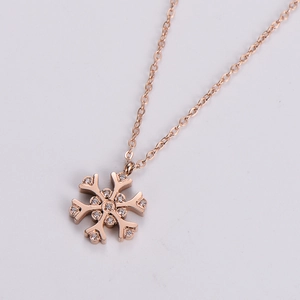 Macro shot of rose gold snowflake necklace with shimmering white zircon stones