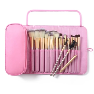 Pink 15pcs makeup brush set with gold handles and foldable storage case in flat lay view