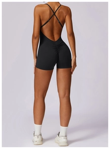 Detail of cross-back straps and scrunch butt lifting design on black yoga bodysuit