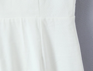 Detail view showing clean stitching and linen fabric texture on white sailor dress