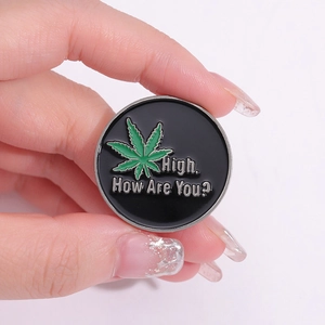 Round enamel lapel pin with green leaf design and High How Are You text detail