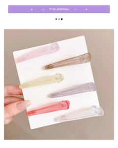 Detailed set of six matte translucent hair clips in soft pastel colors on a white card