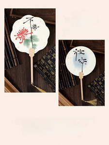 Detailed view of bamboo long handle fans with elegant silk tassels and floral calligraphy