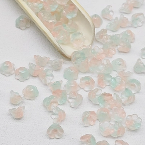 Macro detail of lily-of-the-valley frosted glass flower beads for DIY jewelry making