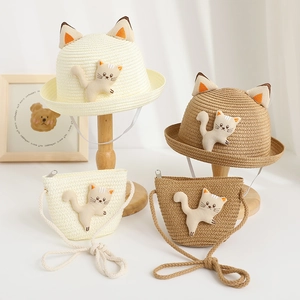 Detail of straw hat and matching kitten bag set with 3D cartoon cat ears and soft texture