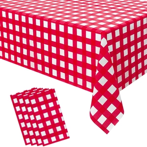 Detail of red and white checkered waterproof tablecloth with matching folded napkins