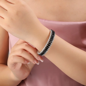 Macro detail of luxury silver bangle featuring double rows of zircons and marquise black stones