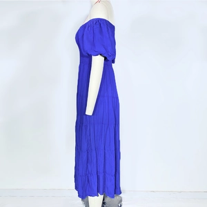 Detail of blue off-shoulder tiered maxi dress with puff sleeves and crinkle texture