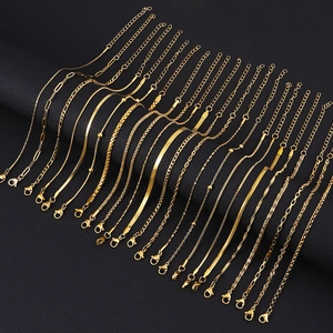 Variety of 18K gold plated stainless steel chain bracelets on a black leather display