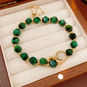 Green malachite beaded bracelet with gold accents and adjustable drawstring cord