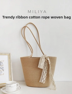 Detail of beige woven cotton rope bag with white lace ribbon on a stylish tabletop