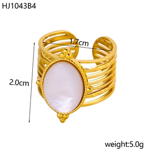 Macro view of vintage gold ring with white oval gemstone and tiered wire design