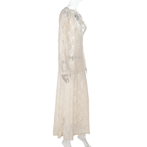 Detail view of lace texture and sheer floral patterns on the long sleeve beige dress
