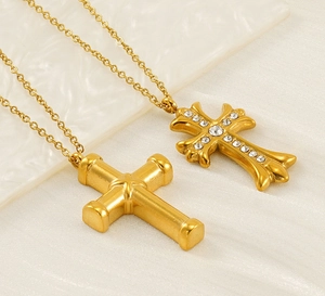 Detail of two gold-plated stainless steel cross necklaces with zircon inlays and O-chains