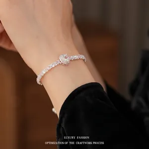 Silver bracelet with pink and white cubic zirconia crystals worn on a female wrist