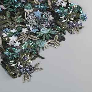 Detail of heavy sequin floral embroidery on black mesh for a sexy formal tube dress