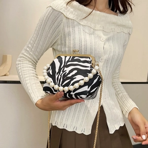 Fashionable zebra print clutch with pearl top handle and metal chain shoulder strap