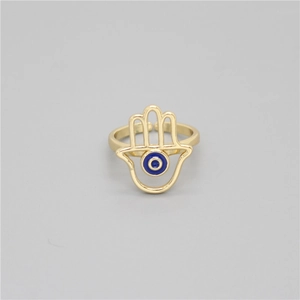 Detail of adjustable gold Hamsa Hand ring featuring a blue enamel Evil Eye design