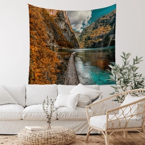 Detail of landscape wall tapestry featuring autumn mountains and lake in a modern living room