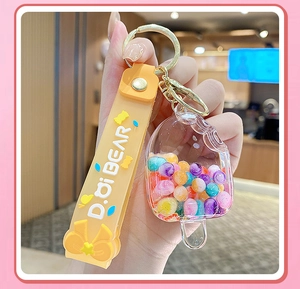 Close-up of popsicle acrylic keychain with colorful beads and orange silicone strap