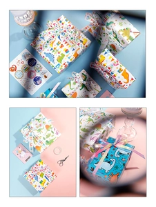 Detail of dinosaur birthday gift wrap set with colorful ribbons and cartoon stickers