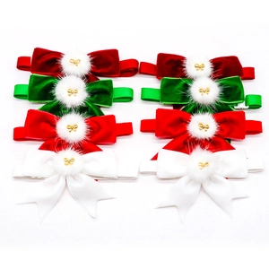 Close-up of velvet Christmas pet bow ties in red green and white with plush balls