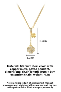 Detailed view of lucky clover tassel necklace with gold plating and sparkling cubic zirconia