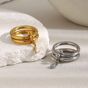 Detail of 18K gold and silver double layer rings with marquise water drop zircon charms