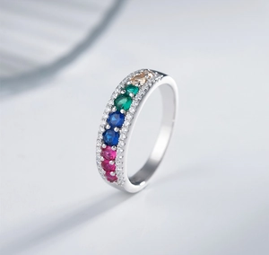 Macro view of rainbow gemstone rows on a polished 925 silver plated gold ring